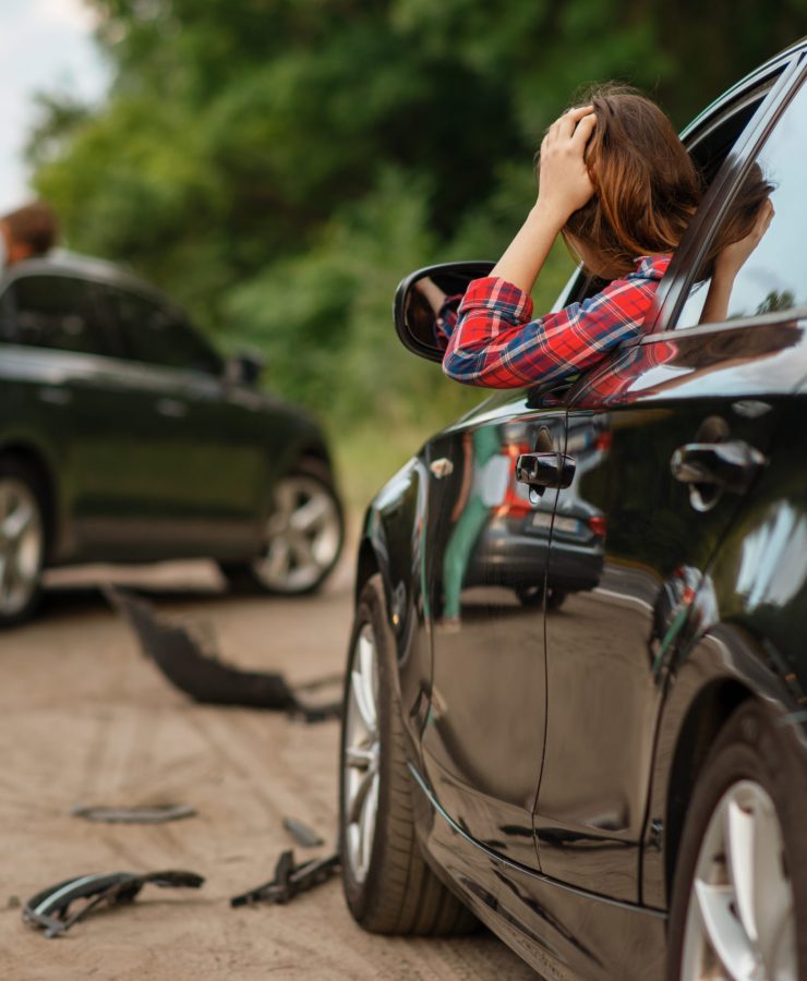 Male and female drivers after car accident on road. Automobile crash. Broken automobile or damaged vehicle, auto collision on highway